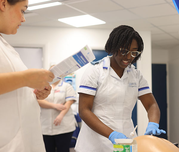 a student is working on a manikin