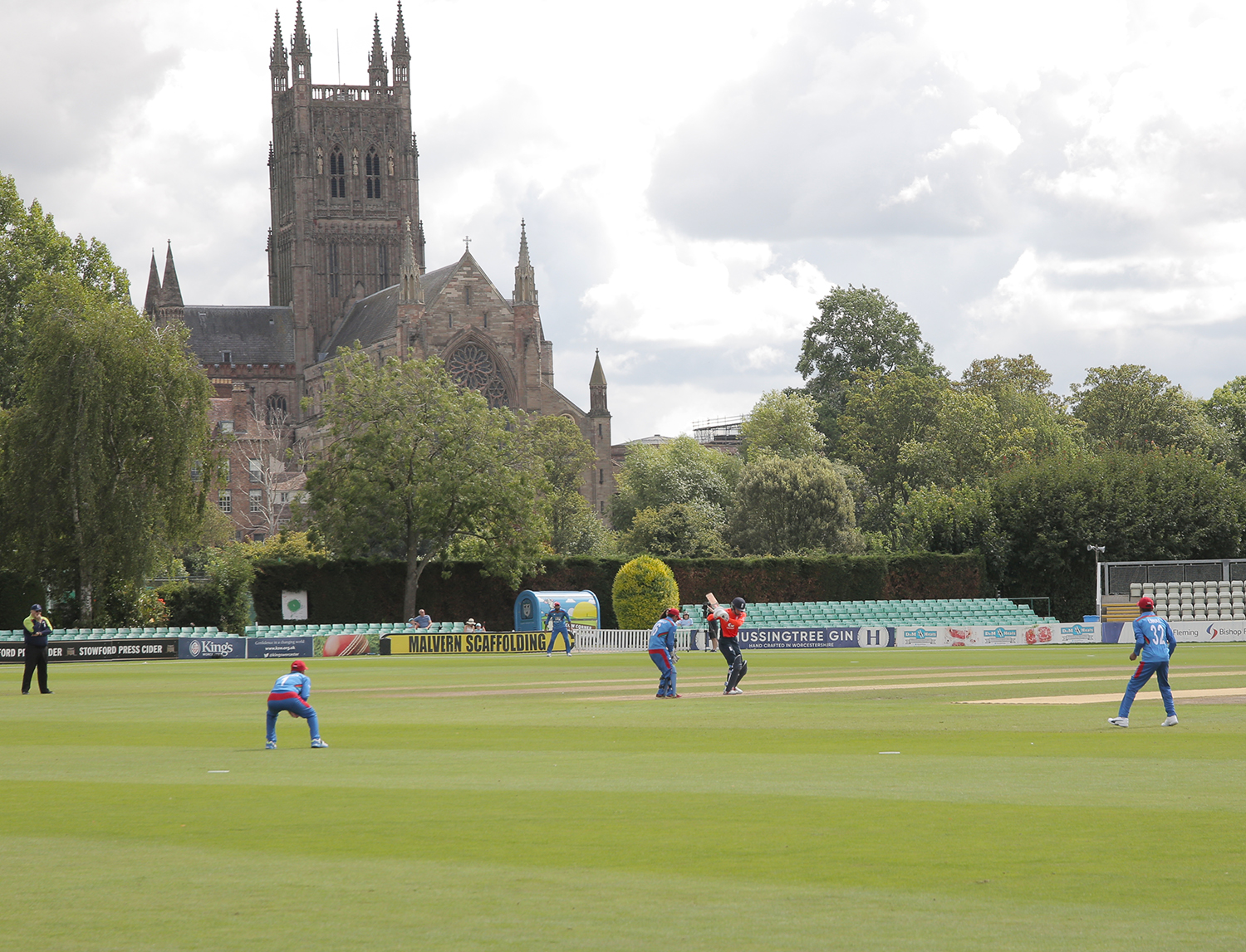 Students playing cricket at New Road with Worcester cathedral in the background