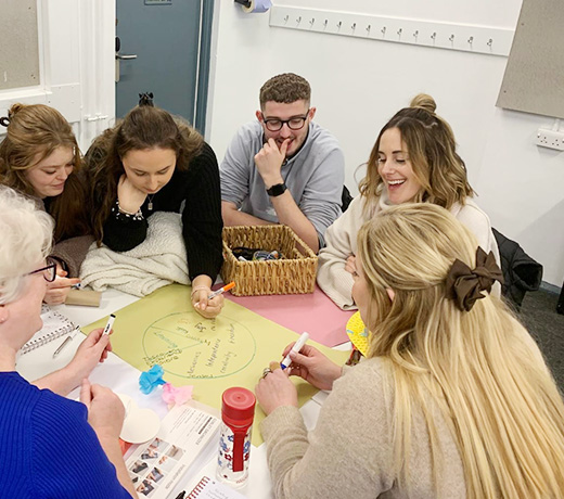 A group of students working together on a pie chart diagram