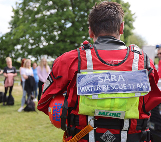 The water rescue team speaking to a large group of students