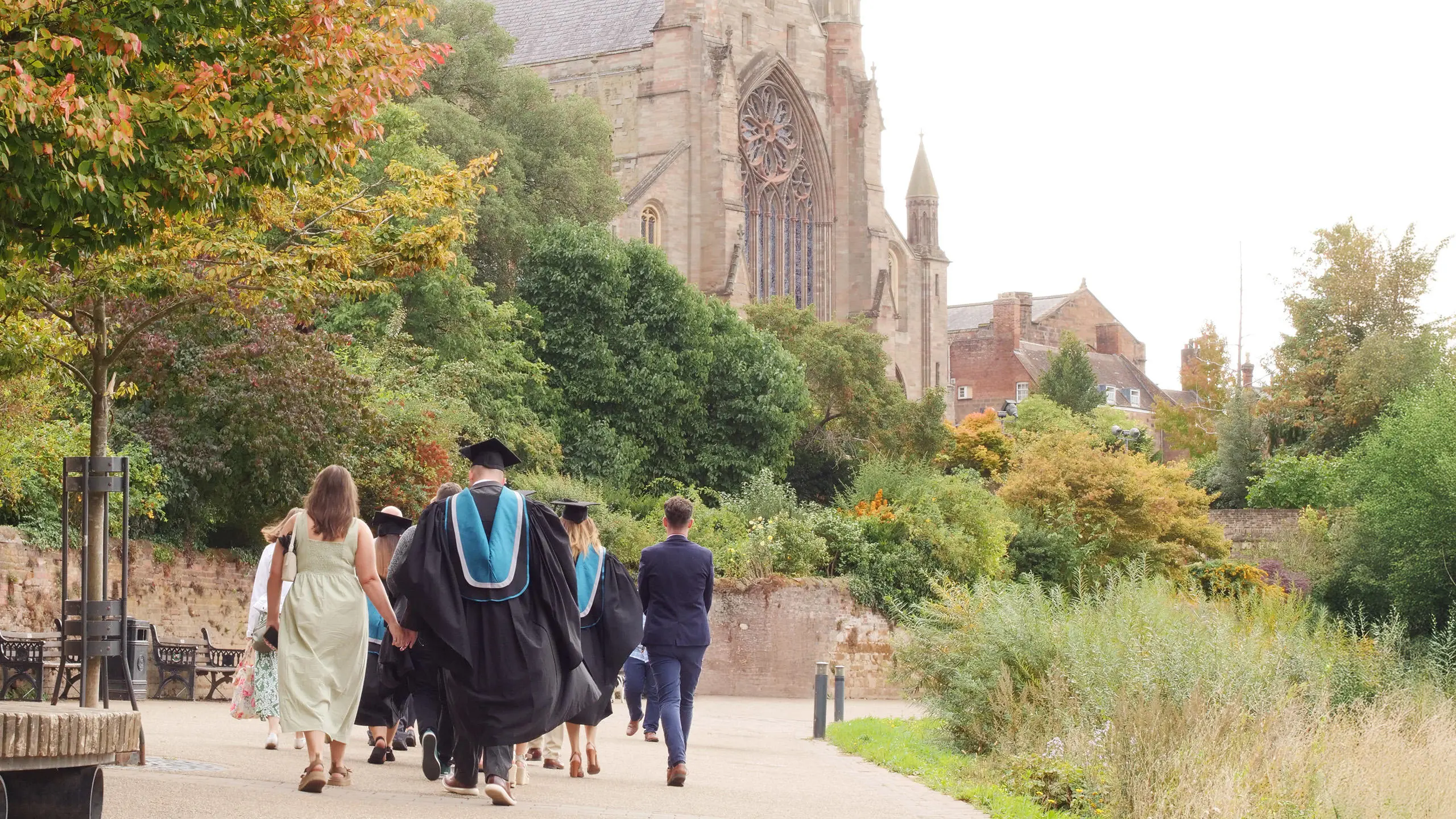Graduates and their families walking towards Worcester Cathedral