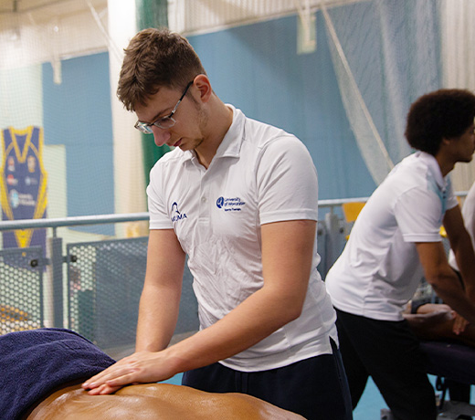 Sports therapy students providing sports massage