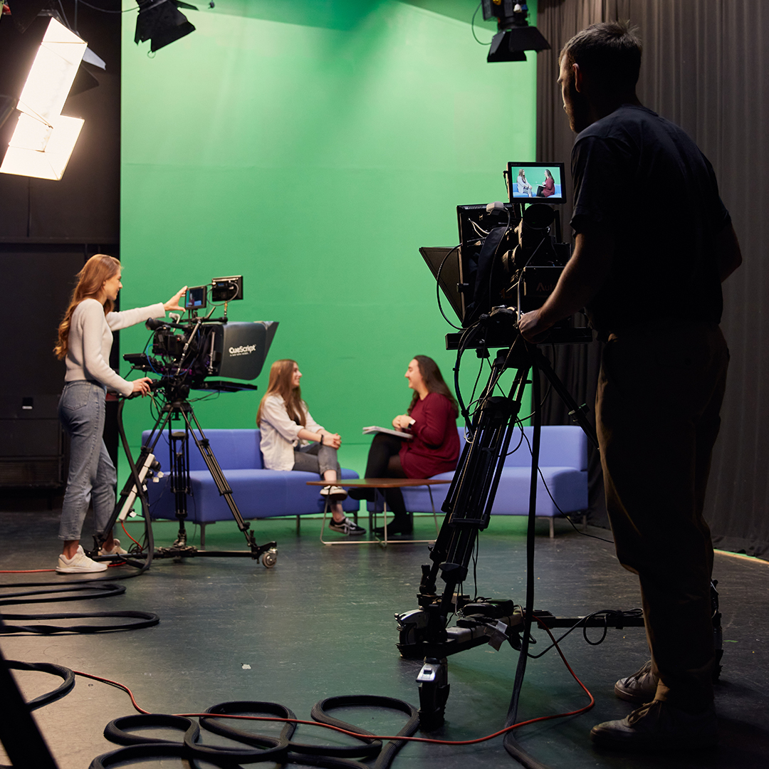 Two cameras filming a conversation