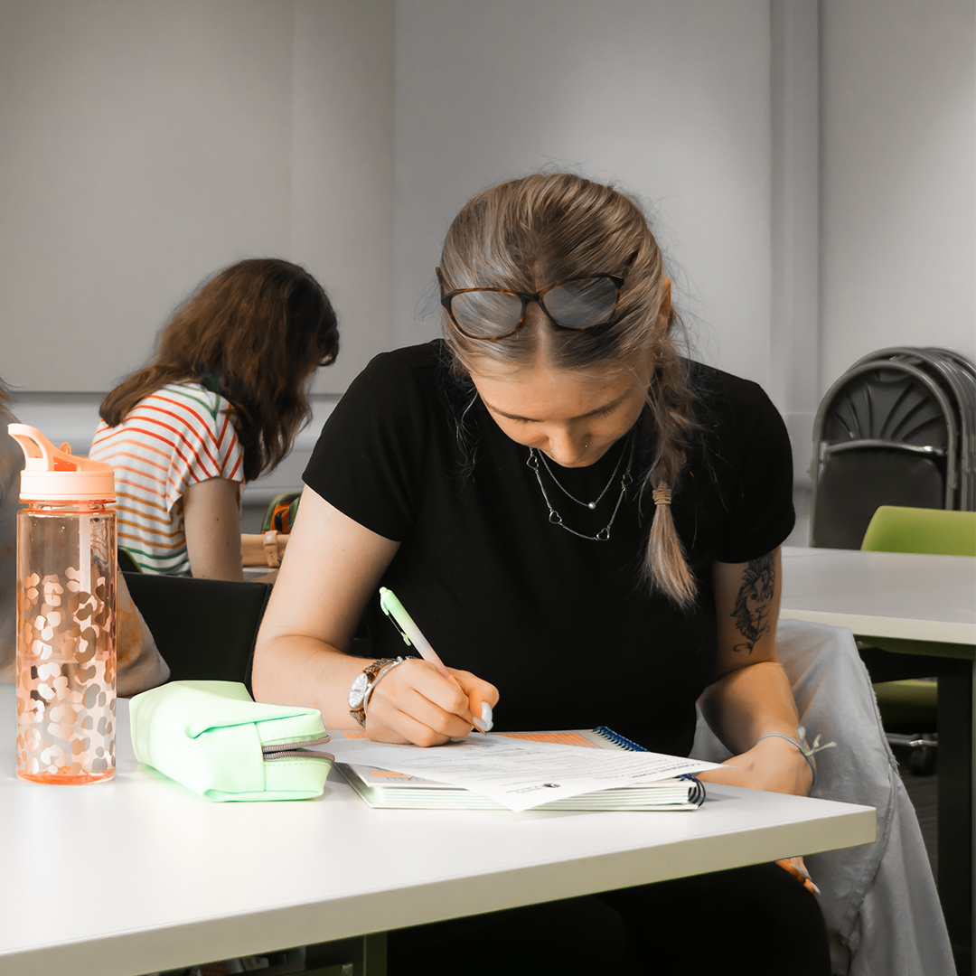 A woman writing in a notebook