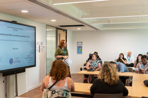 A presenter delivering a talk during the PGR Conference