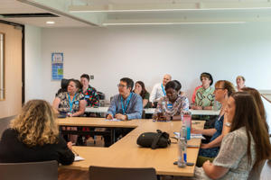 A room of attendees of the PGR Conference, listening to a talk