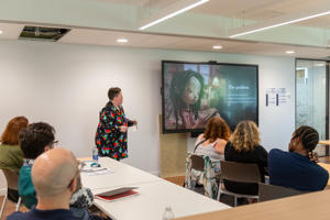 A presenter delivering a talk for the PGR Conference