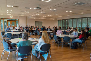 A room of attendees for a talk as part of the PGR Conference