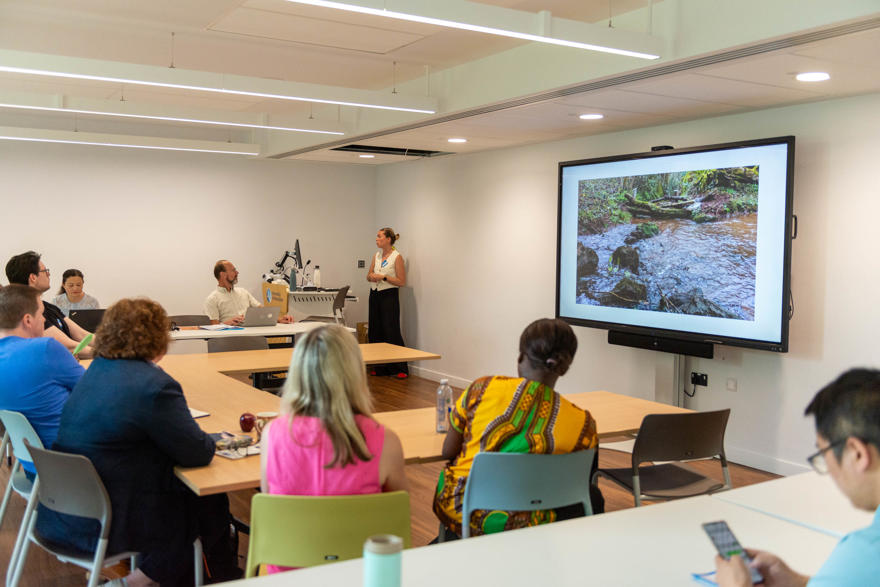 A speaker delivering a talk at the PGR Conference