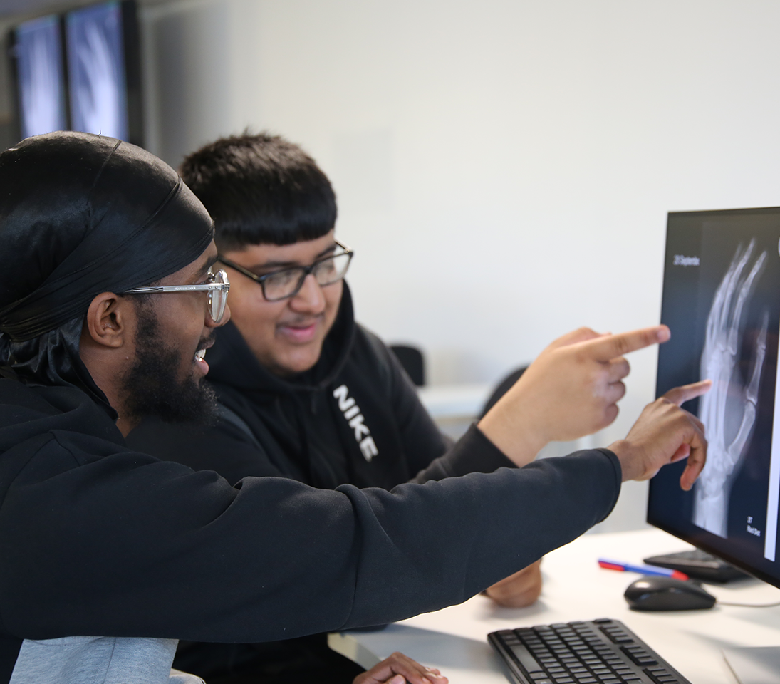 Radiography students looking at a hand scan