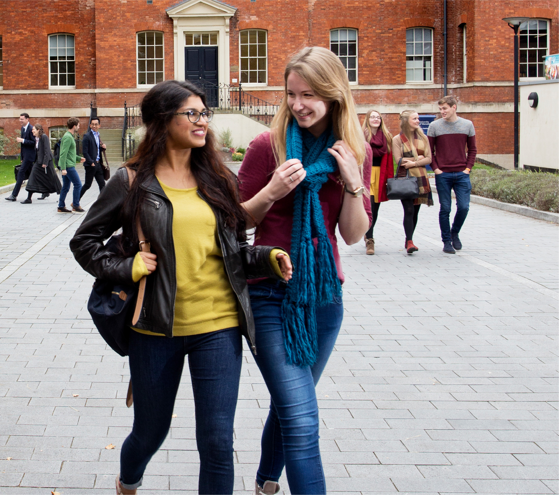 Two students walking in front of the Charles Hastings building