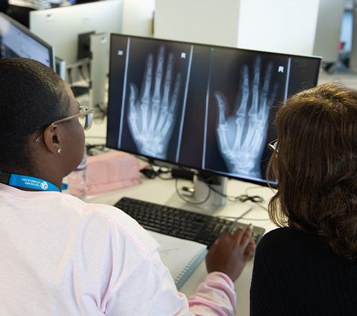 Two students looking at an x-ray of a hand