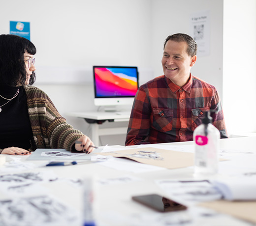 A lecturer talking to an arts student