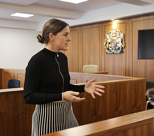 A lecturer addressing students in the mock court room