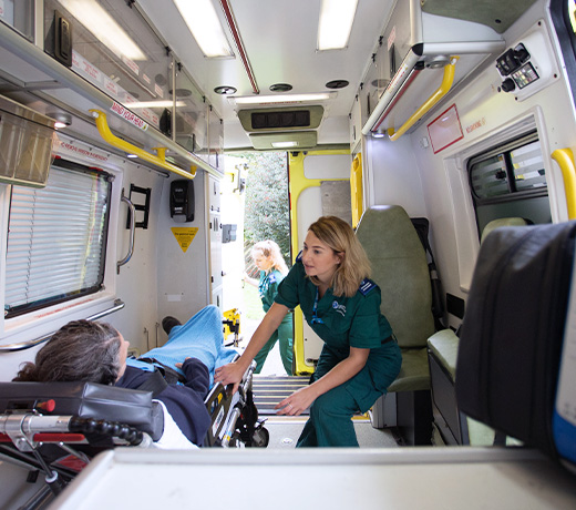 A Paramedic student tending to a patient inside an ambulance