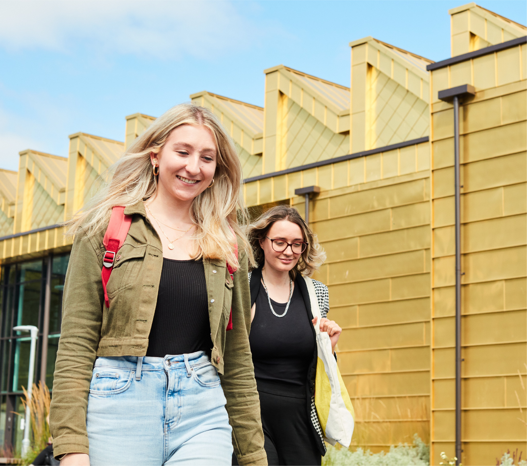 Two students walking away from the Elizabeth Garrett Anderson building