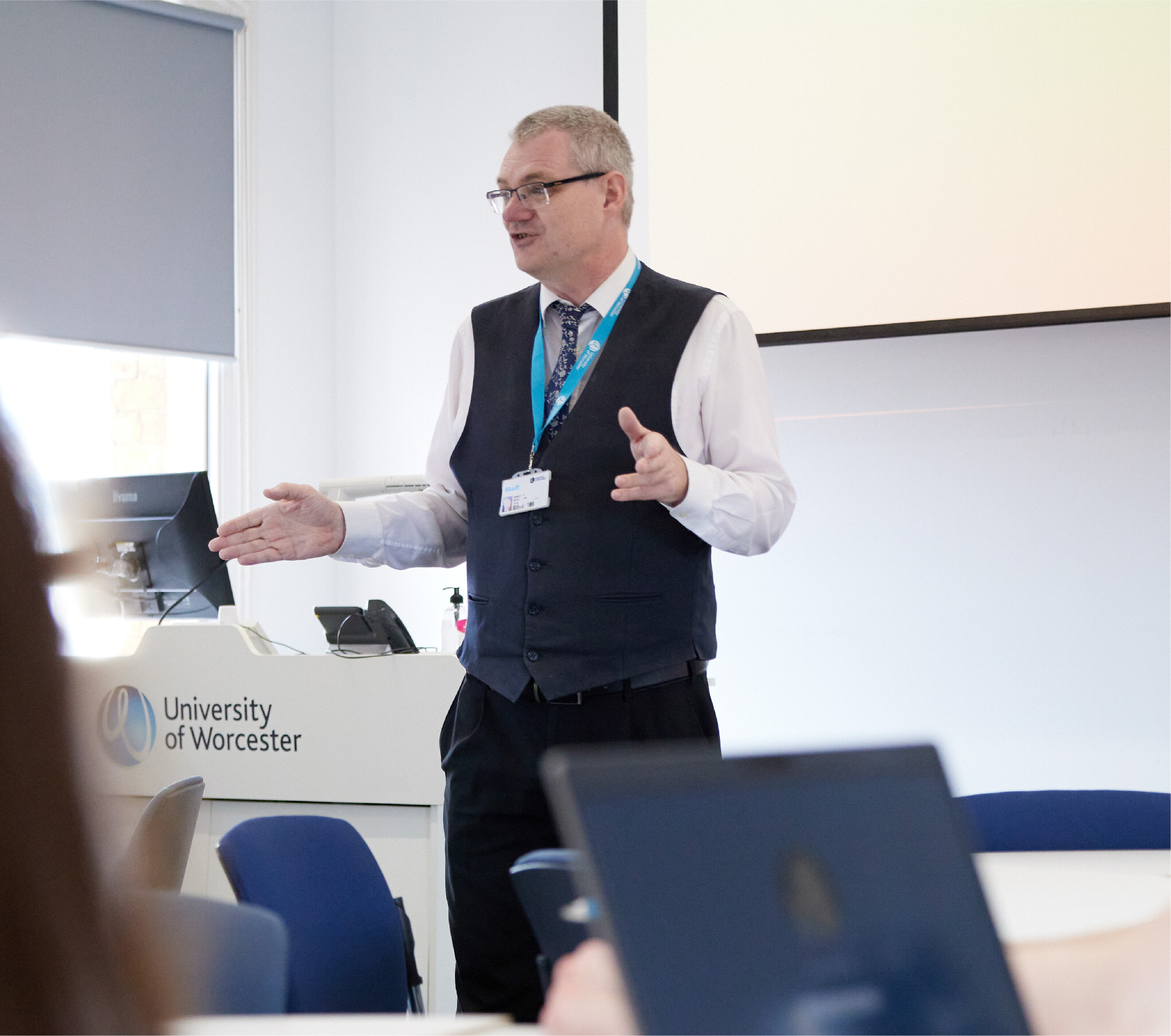 A lecturer talking in front of a class