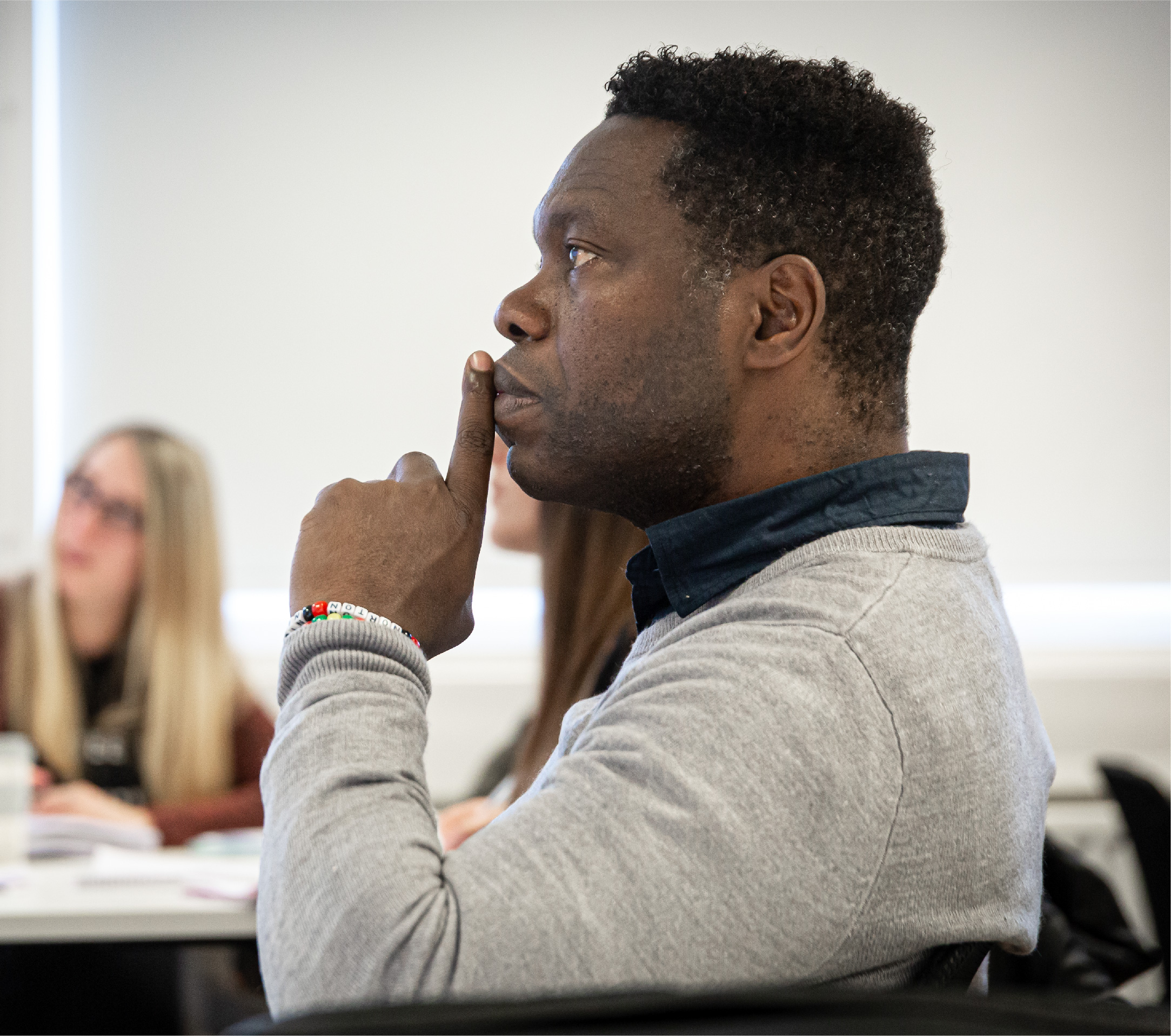 A student deep in thought during a lecture