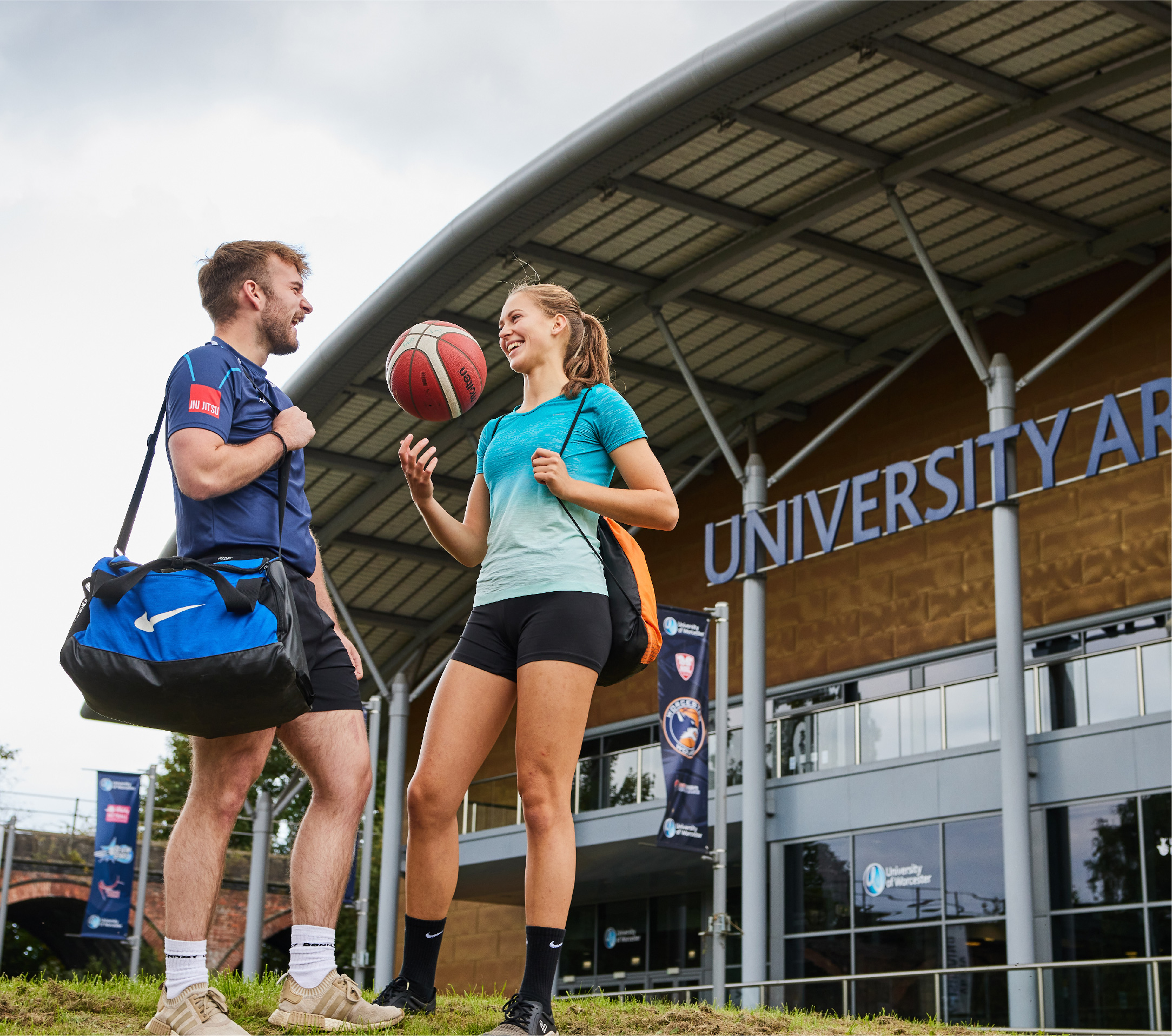 Two sports students talking outside the University Arena