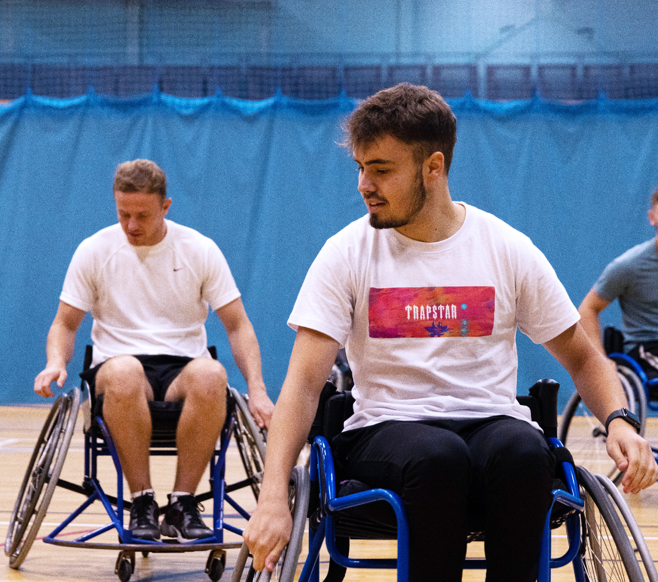 Students in the University Arena playing wheelchair basketball