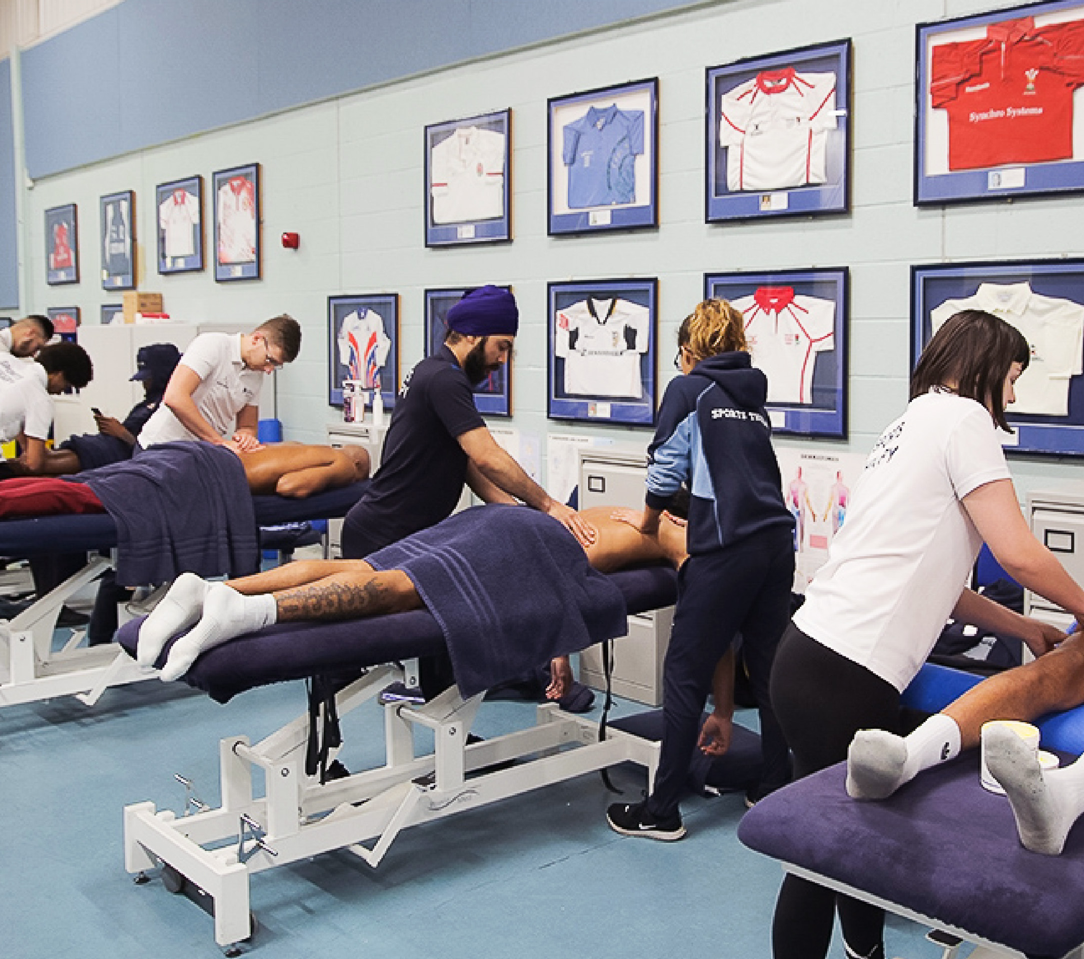 Four groups of Sports therapy students giving massages to sports students