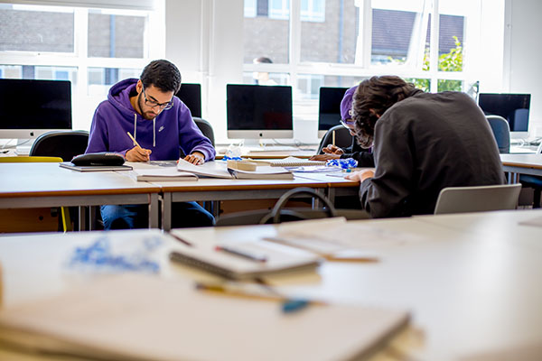 Students sitting at a table writing