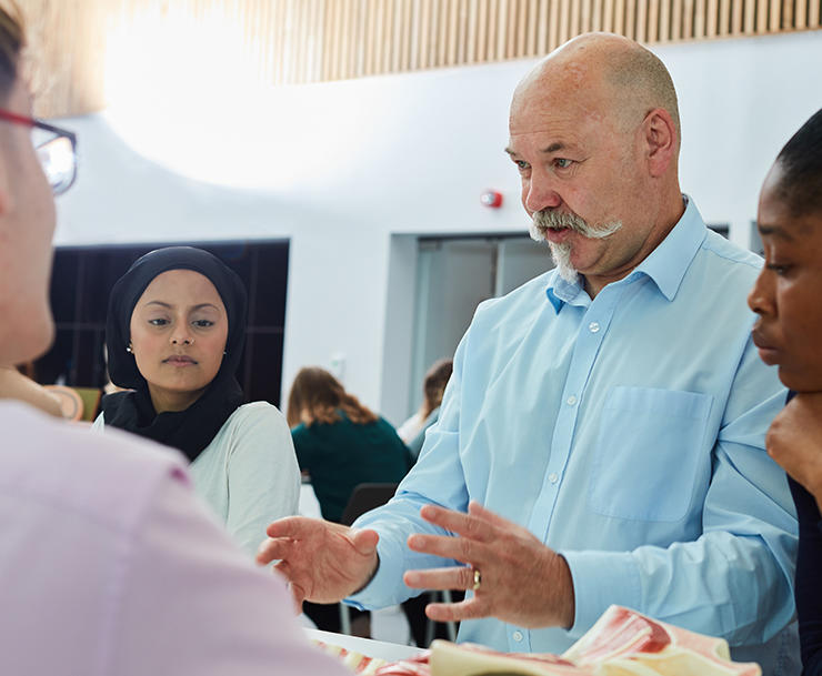 Man talking to group of students