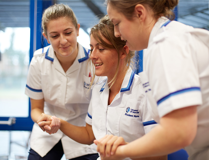 three nurses doing a practical classroom session