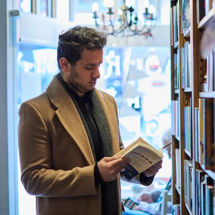 A student reading a book at a local bookshop