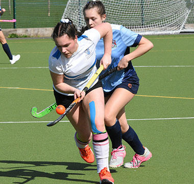 Women playing hockey