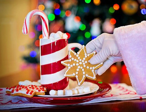 A brightly coloured Christmas biscuit and hot chocolate