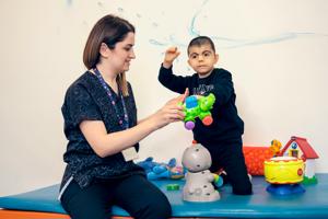 A child and an adult playing with toys