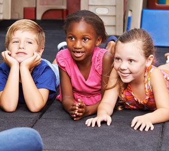 three children lying on the floor